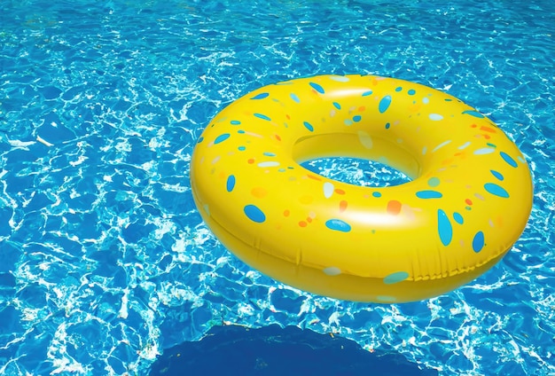 Yellow Swimming Pool Ring Float in Vibrant Blue Water Experience the essence of summer with this delightful image capturing a yellow swimming pool ring float gently floating on the vibrant blue water