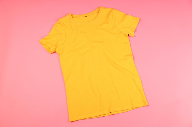 Yellow t-shirt with space for print on pink background