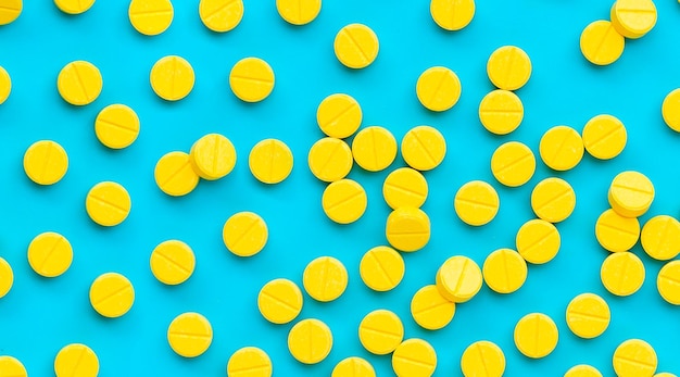 Yellow tablets of Paracetamol on blue background