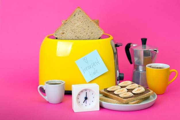 Yellow toaster on a pink background