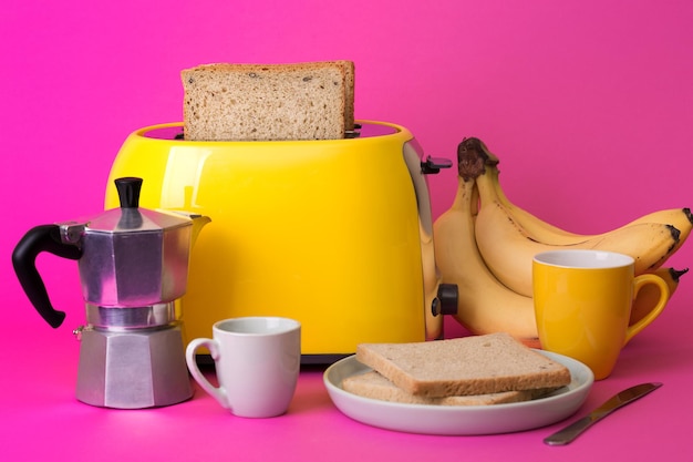 Yellow toaster on a pink background