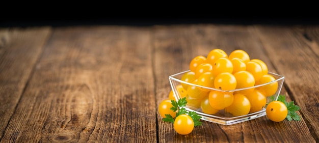 Yellow Tomatoes on wooden background selective focus