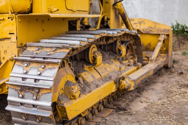 Yellow tractor on crawler track