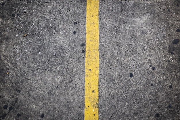 Yellow traffic line on the concrete road 