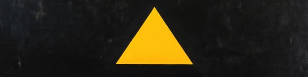 Photo yellow triangle on a black background with a yellow triangle