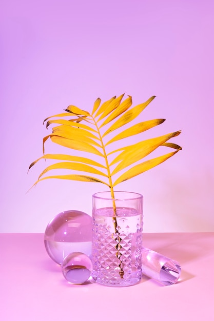 Yellow tropical leaf in water glass still life