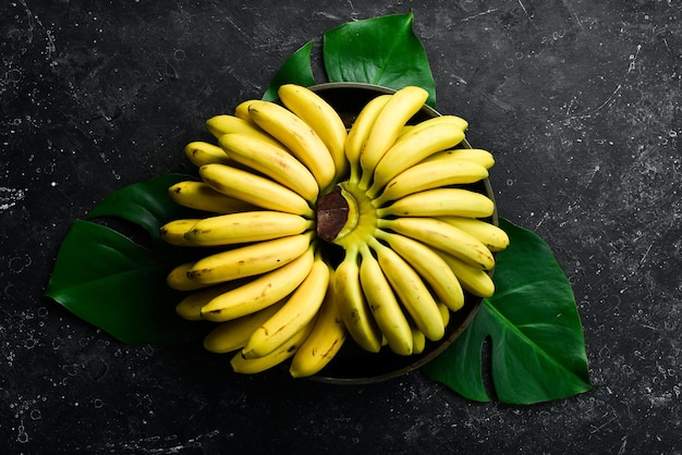 Yellow tropical sweet little baby bananas Free copy space Top view