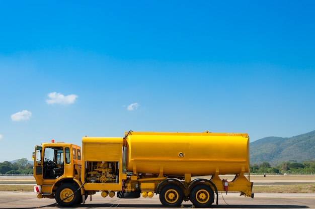 Yellow truck with fuel tank on runway