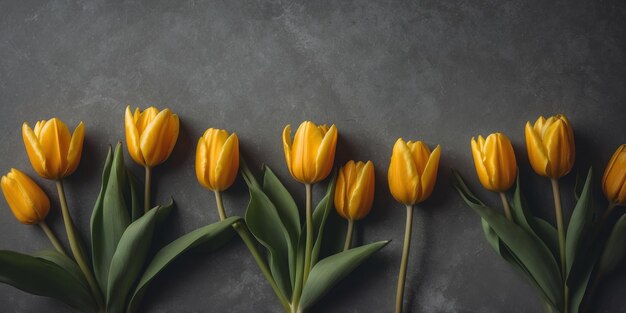 Photo yellow tulips on a gray concrete background