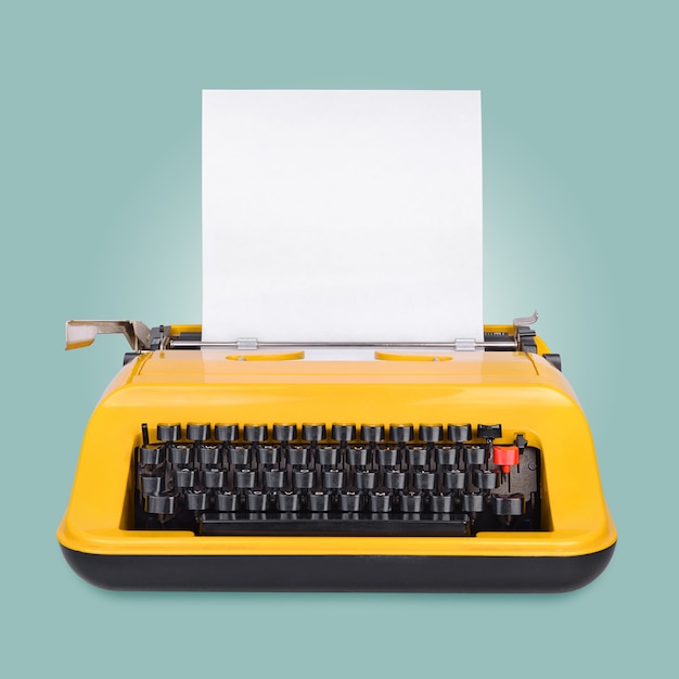 Yellow typewriter with copy space or empty place for your text on blue surface
