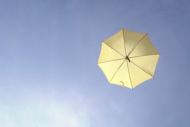 Yellow umbrella on blue sky