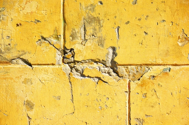 Yellow wall with scratches and chips.