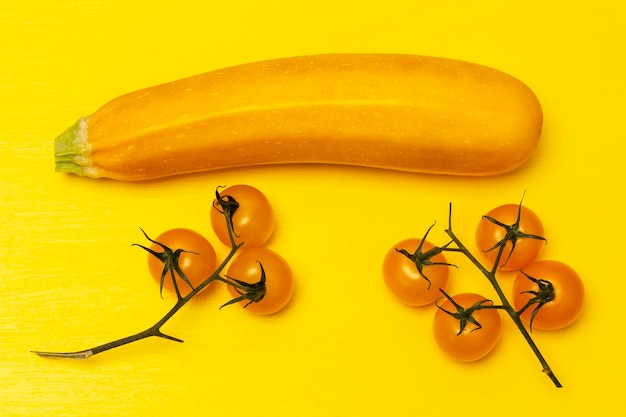 Yellow zucchini and two sprigs of yellow tomatoes