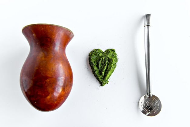 Yerba mate heart on white background and accessories for chimarrao mate tea