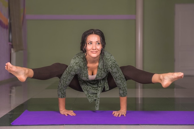 Yoga female doing yoga stretches in the gymLady performing yoga poses in fitness class