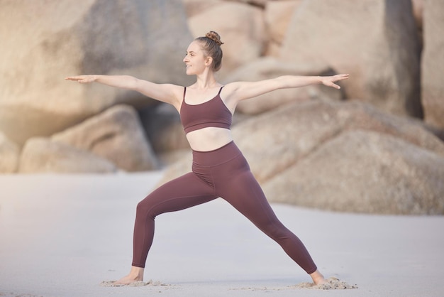 Yoga fitness woman stretching and beach for meditation wellness and health in morning with happy energy Sea sand zen girl and outdoor exercise in workout training or mindfulness for healthy body