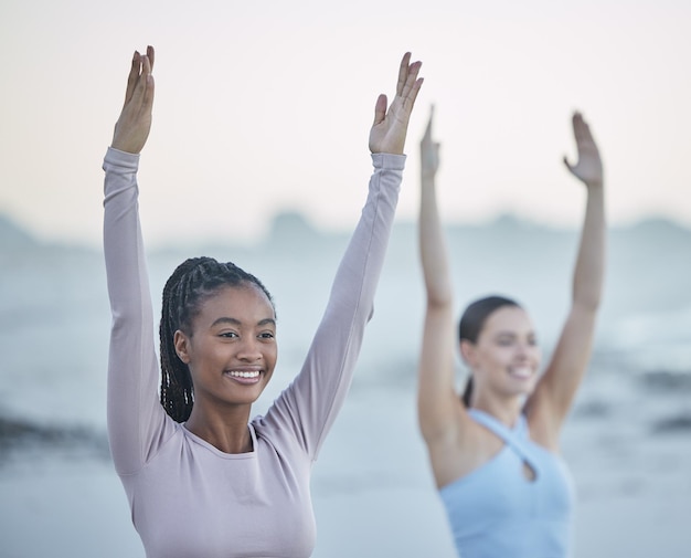 Yoga friends fitness and exercise outdoor in nature for happiness peace and balance during tree pose workout to relax Black woman with pilates partner at beach for morning mindfulness for health