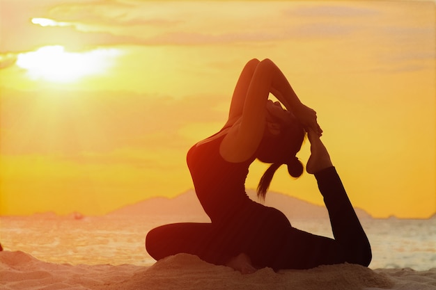 Yoga girl on the beach