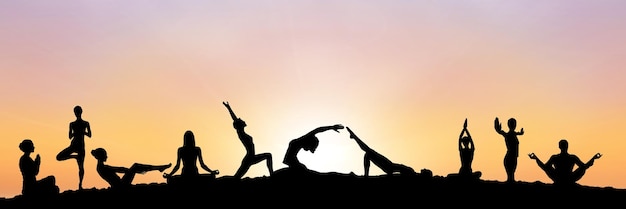 yoga group silhouette at sunset