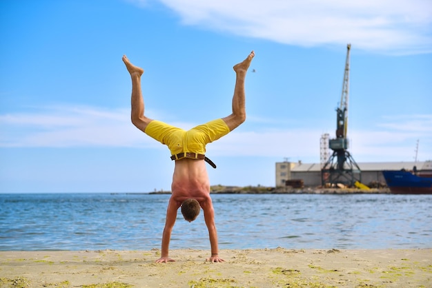 Yoga man standing on hands