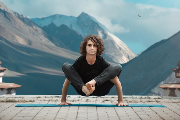 Yoga man Young man doing yoga in loft on sunrise