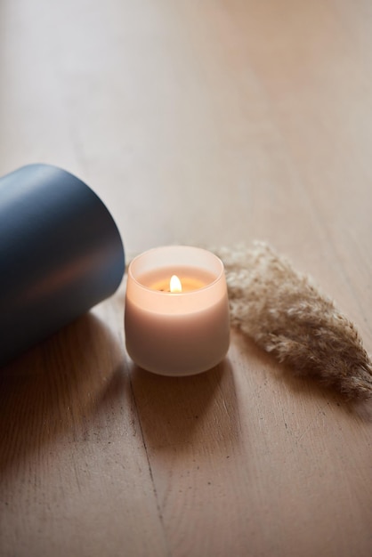 Yoga mat and burning candles on floor