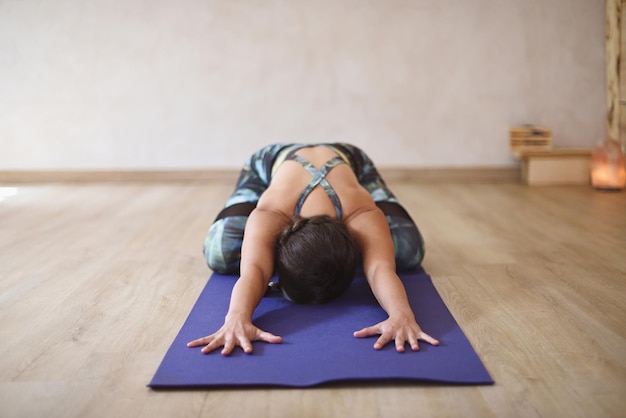 Yoga natural background with woman stretching on rack in room