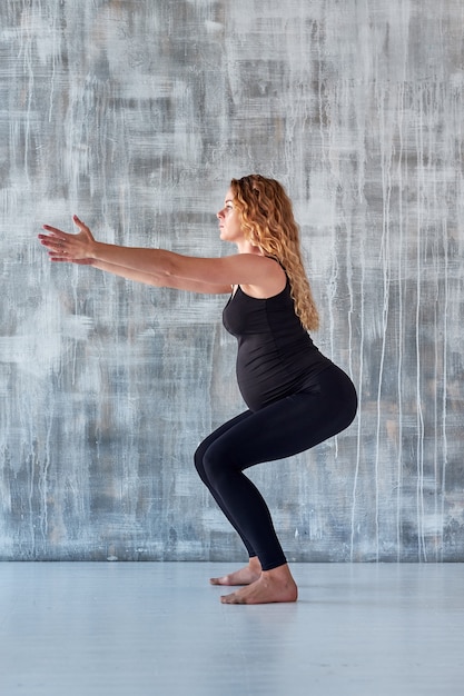 Yoga. Pregnant woman practicing yoga meditation . Health lifestyle concept and baby care