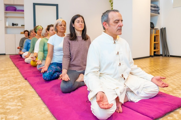 Yoga teacher leading a meditation in a community