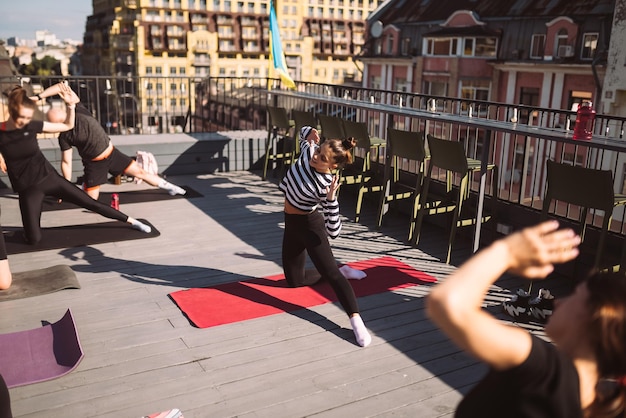 Yogi woman and diverse group of sporty people practicing yoga