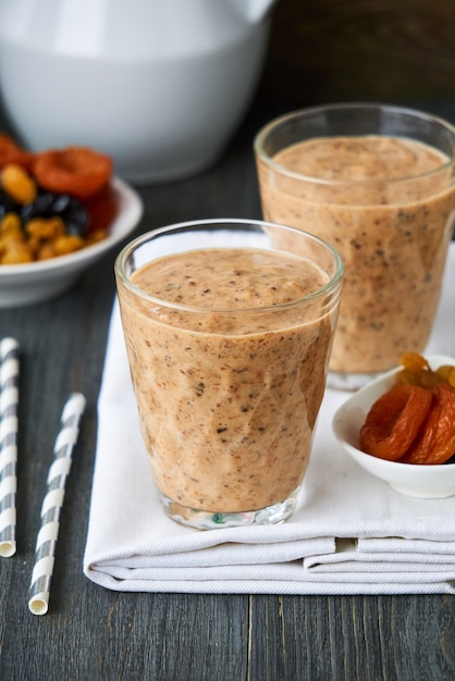 Yogurt smoothies with dried fruit on a wooden table