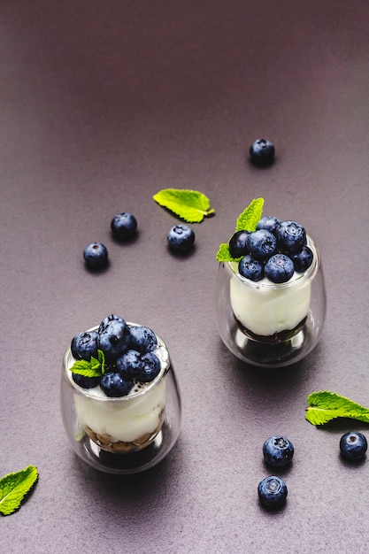 Yogurt with blueberries and chia seeds on cutting board