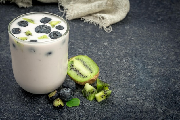 Yogurt with blueberries and kiwi slices closeup