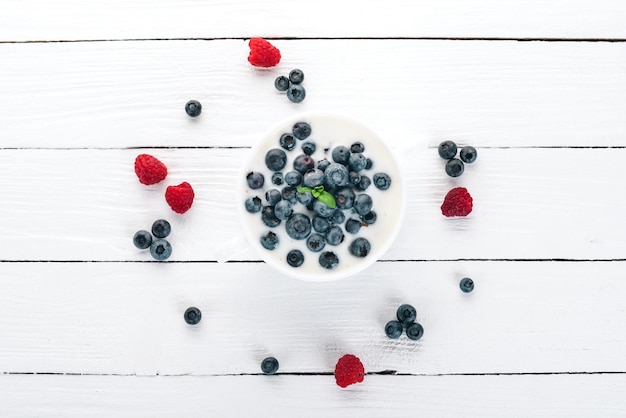 Yogurt with Blueberry Breakfast On a wooden background Top view Free space for text