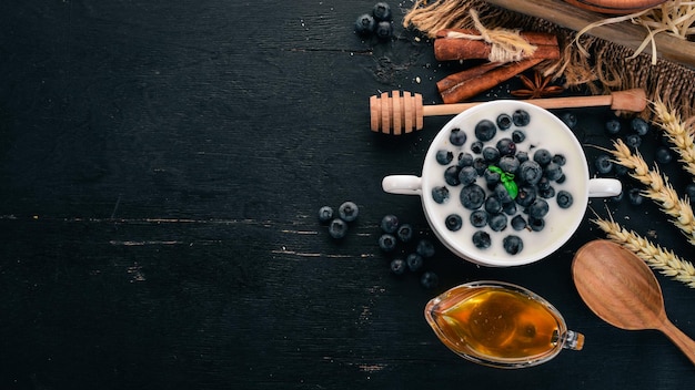 Yogurt with Blueberry Breakfast On a wooden background Top view Free space for text