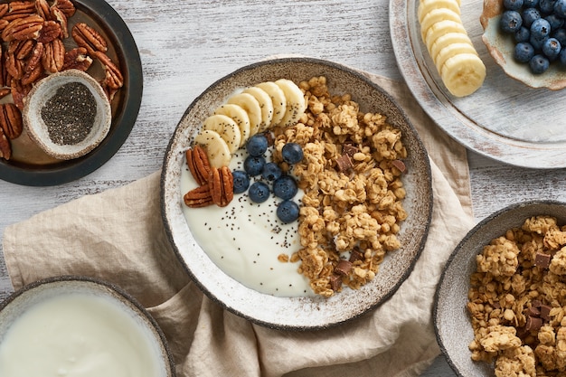 Yogurt with chocolate granola, bilberry. Breakfast, healthy diet food with oat flakes