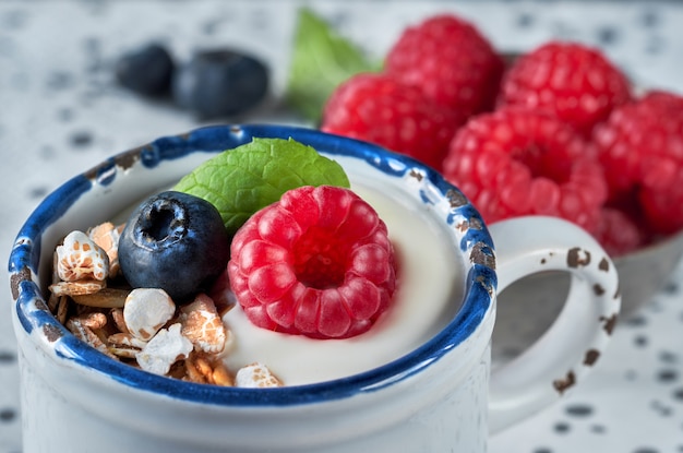 Yogurt with muesli, raspberry and nuts, healthy dessert