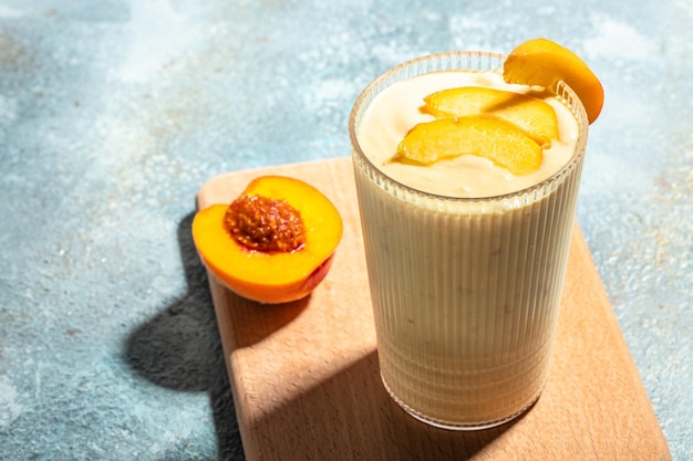 Yogurt with peaches Summer breakfast drink fresh blended peach smoothie place for text