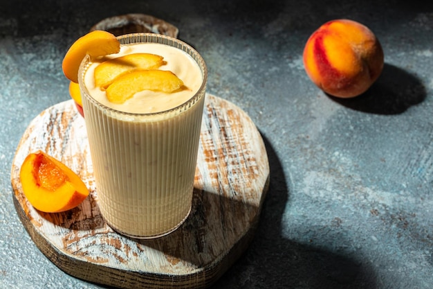 Yogurt with peaches Summer breakfast drink fresh blended peach smoothie place for text