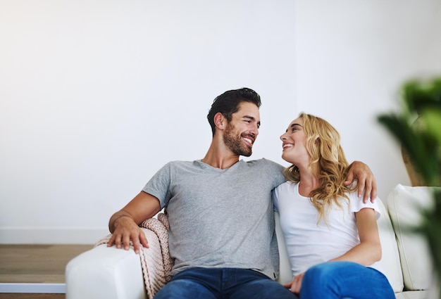 You couldnt find a happier home shot of a young couple relaxing at home