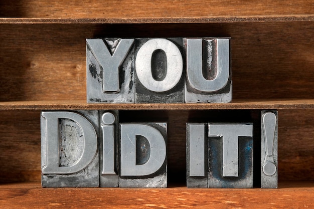 Photo you did it exclamation made from metallic letterpress type on wooden tray