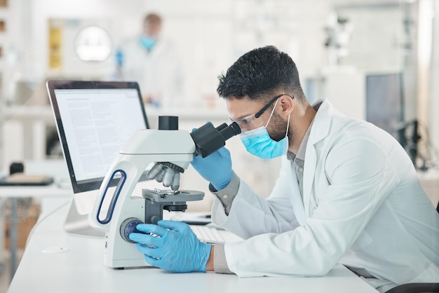 You have to look at it from different perspectives Shot of a young scientist using a microscope in a lab