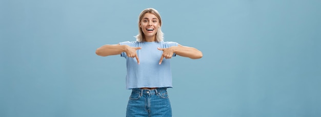 You have to see this portrait of joyful amused and happy stylish blonde female in trendy tshirt