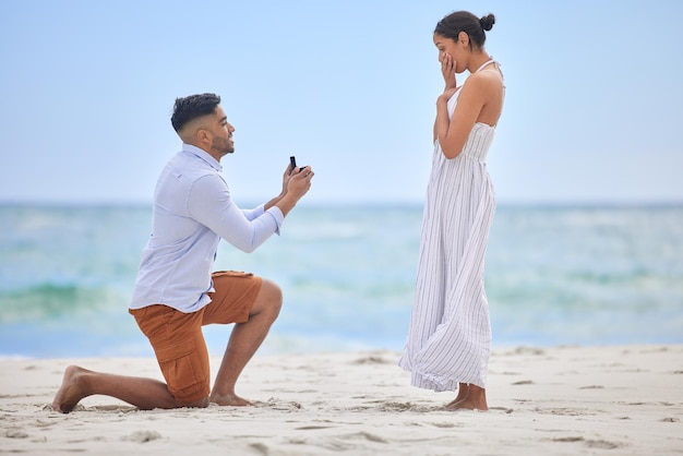 You make me the happiest Ive ever been Shot of a young man proposing to his girlfriend on the beach