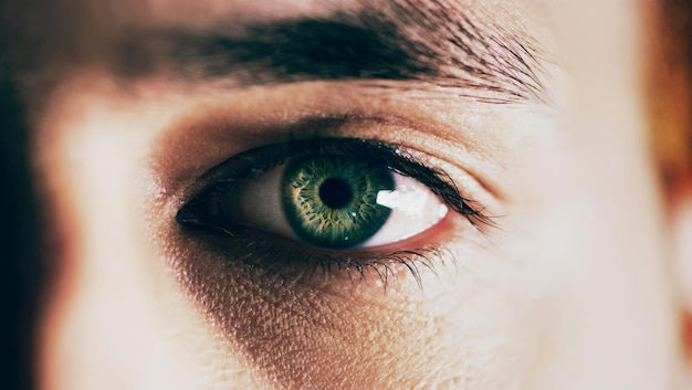 You see nature in his eyes Closeup shot of man opening his eyes against a dark background