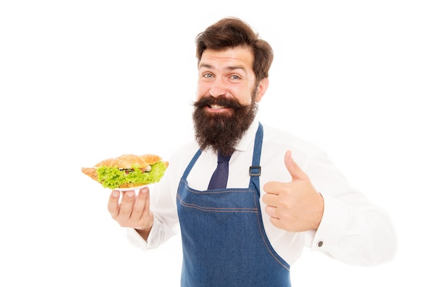 You will like his cooking. Bearded man give thumbs up to dish. Happy cook enjoy cooking food. Confident in his cooking skills. Cooking healthy and energetic food.