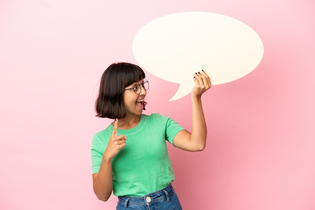 Youing woman holding an empty speech bubble and thinking