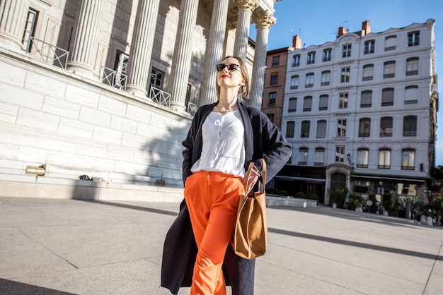 Younf stylish woman walking in the old town of Lyon city in France