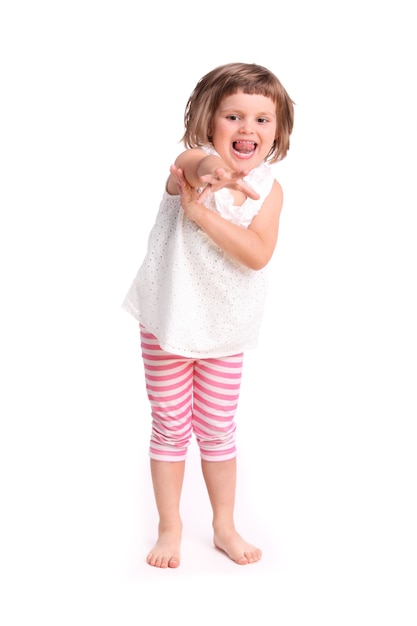 a young adorable girl trying to reach something over white background