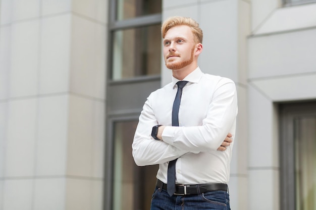 Young adult attractive worker crossed hands looking away and dreaming